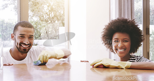 Image of Happy couple, portrait and home for cleaning furniture, table and housekeeping maintenance. Face of man, woman and smile together to wipe surface for dust, bacteria and responsibility of disinfection