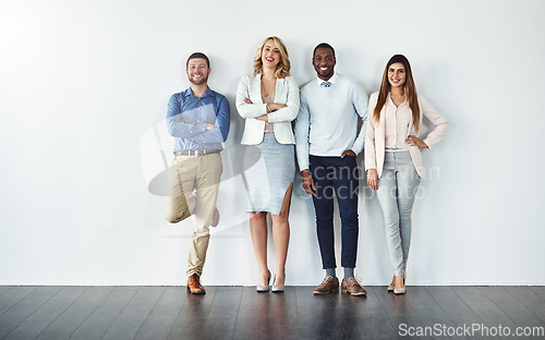 Image of Portrait, diversity and collaboration with business people in studio together against a gray wall for mockup. Teamwork, confidence or professional with a group of colleagues in the office for success