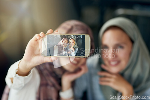 Image of Islamic woman, friends and selfie with phone, smile and happiness for post on blog, web or social media. Happy muslim women, screen and smartphone for photography, profile picture and memory on app