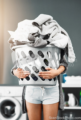 Image of Laundry basket, pile and woman with clothes in her home for housework, washing and hygiene. House, cleaning and female carrying fresh fabric for spring clean, tidy and household task on the weekend