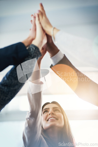 Image of Business people, group high five and together for motivation, support or happiness for goals in insurance company. Team building, hands and connection with synergy, teamwork and success in workplace