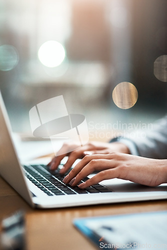 Image of Laptop, typing and hands of a person at desk for work, internet and connection at night. Business, corporate and a secretary or receptionist on a computer keyboard for late admin online in an office