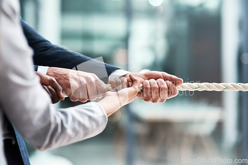 Image of Hands, teamwork and rope with business people grabbing during a game of tug of war in the office. Collaboration, help or strength with a team of employees or colleagues pulling an opportunity at work