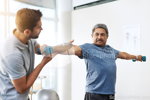 Image of Dumbbells, physiotherapy and help with doctor and patient for rehabilitation, training and stretching. Healthcare, wellness and healing with old man and expert for consulting, muscle and exercise