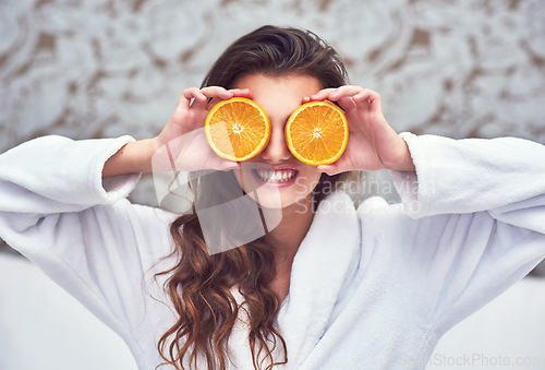 Image of Orange, beauty and smile with woman in hotel for breakfast, diet and relax. Nutrition, health and natural with female model and cover with citrus fruit in bedroom for vitamin c, spa and facial