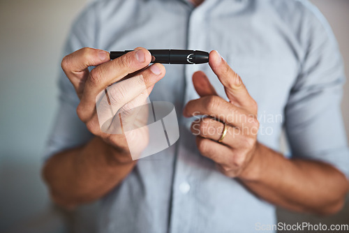 Image of Hands, diabetes and insulin injection with a man closeup in his home for routine treatment of glucose. Health, wellness and blood sugar with a male diabetic taking a medical sample in his house