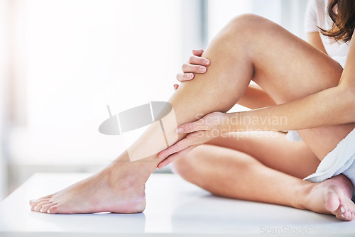 Image of Skincare, feeling and legs of a woman after waxing, grooming and cleaning in a bathroom. Beauty, moisturize and a person touching a leg after shaving or removing body hair for a treatment at home