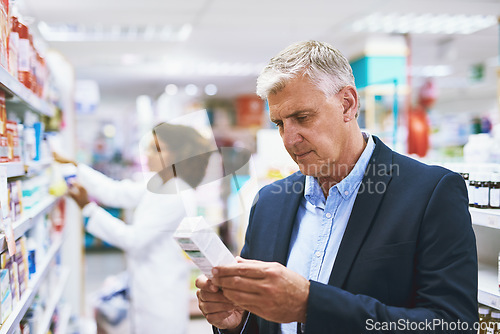 Image of Senior man shopping, reading on medicine or customer in pharmacy for retail healthcare pills or product. Information, businessman or mature customer searching for medication or medical drugs on shelf