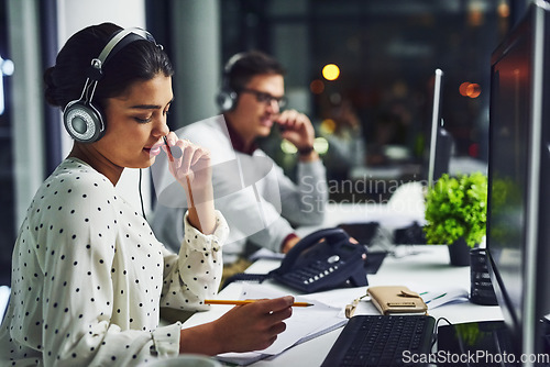 Image of Call center, customer service and a woman at night, working in the office for consulting or assistance. CRM, contact us and support with a female consultant using a headset to help a client online