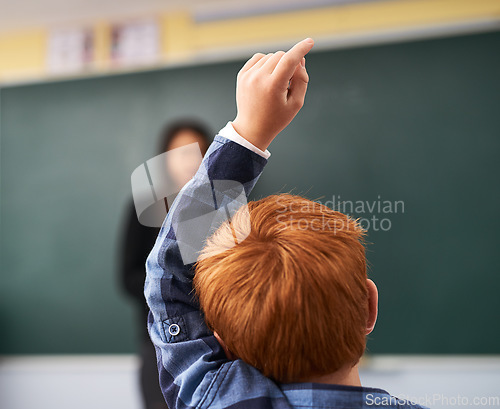 Image of Child, question and student in classroom with question for teacher, education and learning with school blackboard. Boy, raise arm and questions for knowledge, information and development in class