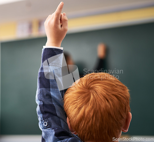 Image of Student, hand and child in classroom with question for teacher, education and learning with school blackboard. Boy, raise arm and questions for knowledge, information and development in class