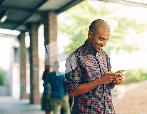 Image of Young man, student and texting with cellphone on campus, university and happy with social media app. Guy, smartphone and happiness outdoor for connectivity, blog and email communication on internet