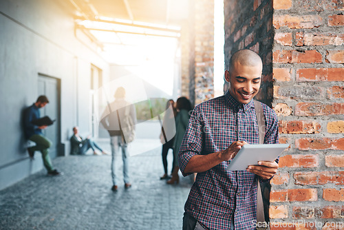 Image of Happy, outdoor and man with a tablet, education and connection for social media, search website for information or network. Male person, guy and student with technology, campus and typing with an app