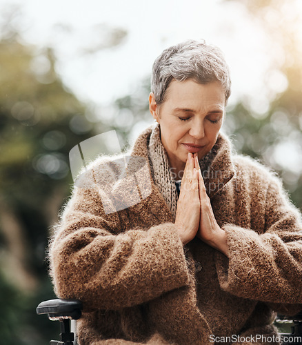 Image of Old woman in wheelchair, praying in garden with worship and God, faith and religion with peace outdoor. Spiritual, female person with disability has gratitude and faith, prayer and guidance