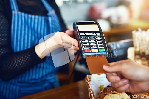 Image of Credit card payment, cafe and hands with a machine at a restaurant for a service or food. Bakery, pay and a customer paying or buying a product at a coffee shop with a transaction from a worker