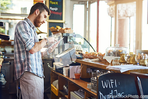 Image of Tablet, cafe owner and man doing inventory while working on a startup business plan in a restaurant. Technology, entrepreneur and male barista doing research on a digital mobile in his coffee shop.