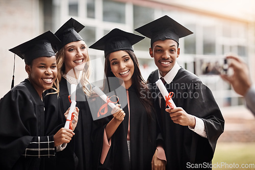 Image of Students, graduation and diploma of a college group with a smile and pride outdoor. Diversity men and women excited to celebrate university achievement, education success and graduate memory or photo