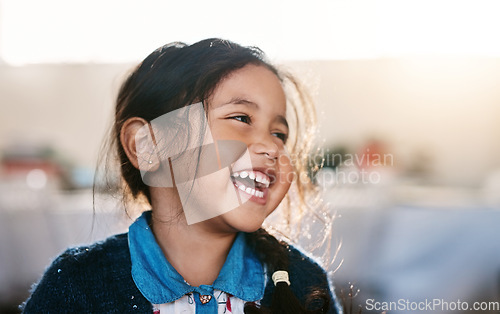 Image of Happy kid, laughing and girl in a living room, playing and having fun in her home. Child, development and Mexican female toddler with funny, joke or reaction to comedy, goofy and comic in her house