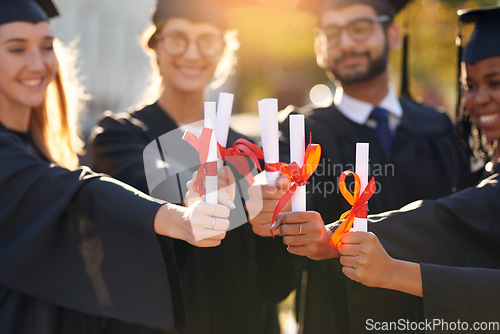 Image of Group, students and graduation diploma with friends hands of college or university people. Men and women outdoor to celebrate education achievement, success and certificate at school for graduates