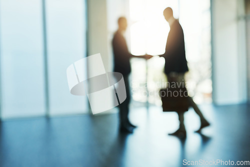 Image of Handshake, silhouette and blur of business people in office for partnership, collaboration and agreement. Corporate, recruitment and and blurred men shaking hands for thank you, welcome and deal