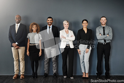 Image of Diversity, smile and portrait of business people in studio for support, community and teamwork. Happy, collaboration and professional with employees and wall background for motivation and mission