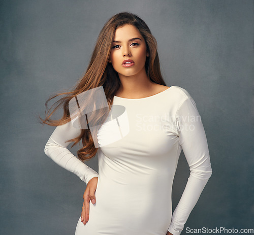 Image of Fashion, confident and portrait of a woman in a dress isolated on a dark background in a studio. Stylish, fashionable and a young lady with clothes style, confidence and elegance on a backdrop