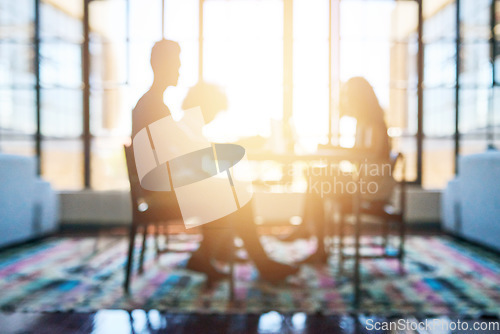 Image of Silhouette, people in business meeting and lens flare or sunlight in modern office planning. Teamwork or collaboration, support and colleagues talking or discussing together at desk in workplace
