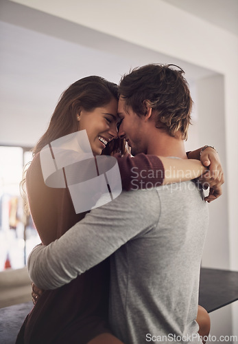 Image of Happy young couple, love and hug in apartment for care, quality time and bonding together for commitment to relationship. Man, woman and lovers hugging for romance, smile and relax with trust at home