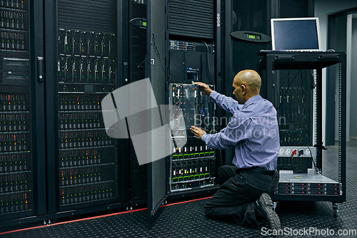 Image of Database, software and a man engineer in a server room for cybersecurity maintenance on storage hardware. Computer network or mainframe with a technician working on information technology equipment