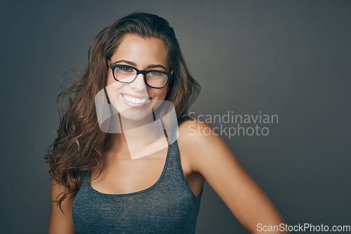 Image of Woman, glasses and portrait with happiness and mockup from eyewear. Gray background, studio and mockup with young female person and model with beauty and casual style with a smile and eye care