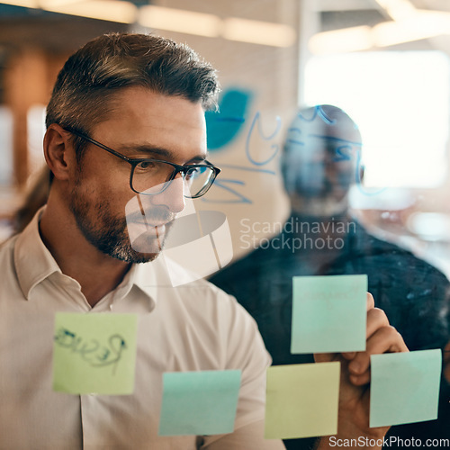 Image of Businessman, writing and planning in team brainstorming for schedule, tasks or strategy at office. Man employee in leadership, presentation or training staff in sticky note project plan at workplace
