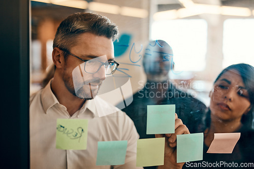 Image of Businessman, writing and planning in meeting for strategy, brainstorming or schedule task at office. Man employee in leadership, presentation or training staff on sticky note for project at workplace