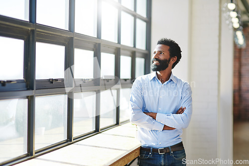 Image of Window, thinking and a business man arms crossed in the office with a smile or vision of future success. Happy, idea and corporate with a male employee standing in the workplace during his break