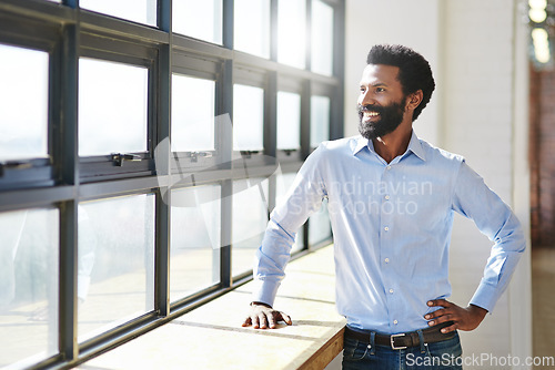 Image of Window, idea and smile with a business man in the office to focus on company growth or success. Happy, vision and thinking with a male employee standing hand on hip in the workplace during his break