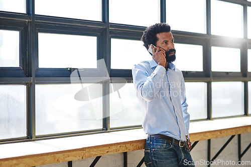 Image of Window, phone call and a business man in the office for communication or networking with flare. Management, mobile and contact with a serious male employee standing in the workplace during his break
