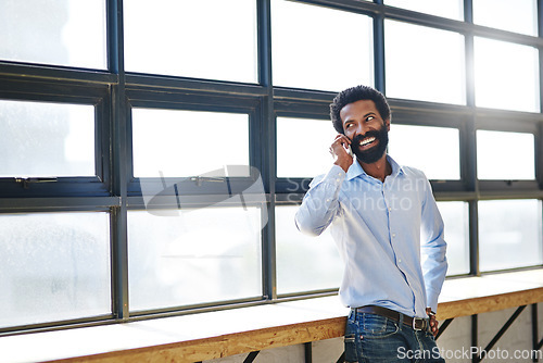 Image of Window, phone call and thinking with a business man in the office for communication or networking. Happy, vision and idea with a happy male employee chatting in the workplace during his break