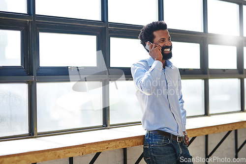 Image of Window, phone call and smile with a business man in the office for communication, networking or negotiation. Happy, vision and mobile with a male employee talking in the workplace during his break