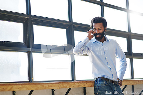 Image of Window, thinking and phone call with a business man in negotiation at the office for planning or opportunity. Idea, vision and communication with a male employee in the workplace during his break