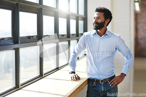 Image of Window, flare and thinking with a business in the office to focus on future success or company vision. Idea, mindset and corporate with a male employee standing in the workplace during his break