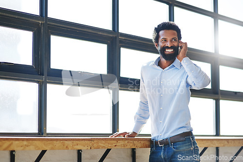 Image of Window, phone call and communication with a happy business man in the office with a smile or mindset of the future. Happy, mobile and contact with a male employee talking at work during his break