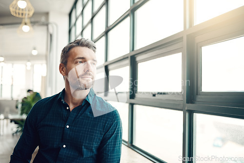 Image of Thinking, focus and businessman at window, creative startup and business project for entrepreneur at design agency. Proud boss with creativity, ideas and focus, man with plan for future in workplace.