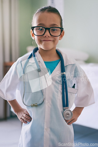 Image of Girl child, portrait and play doctor with smile, glasses and stethoscope in home, hospital or clinic. Female kid, playing medic and happy with excited face, learning and game for development in house