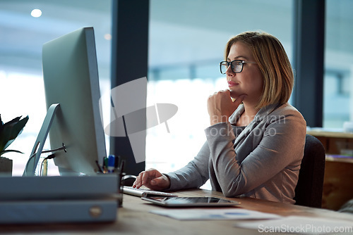 Image of Computer, thinking and business woman in office working late on project at night alone. Desktop, professional and female person problem solving, focus or solution, planning or reading on deadline