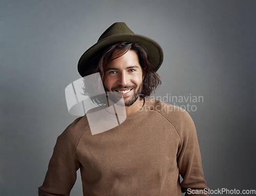 Image of Portrait, hat and smile of man in studio isolated on a gray background. Face, fedora and handsome male person or model from Australia with happiness for fashion, stylish and trendy aesthetic mockup.