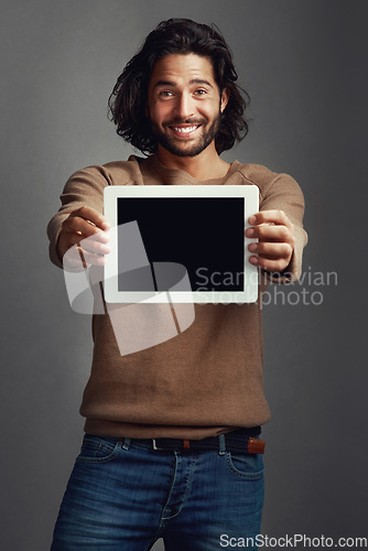 Image of Tablet screen, portrait and smile of man with mockup in studio isolated on a gray background. Touchscreen, face and male person with marketing, advertising and technology for commercial promotion.