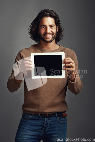 Image of Portrait, tablet screen and smile of man with mockup in studio isolated on a gray background. Touchscreen, face and male person with marketing, advertising and technology for commercial promotion.