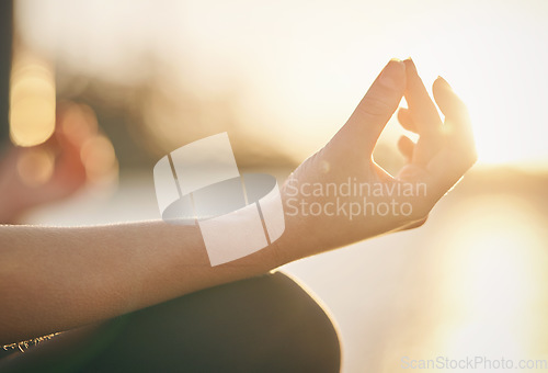 Image of Hand, yoga and lotus pose with woman at sunrise, fitness outdoor with meditation and wellness for mental health. Sunshine, female person meditate and zen with exercise, healing and mindfulness