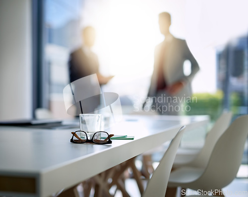 Image of Business people, boardroom and interior for meeting, partnership or corporate discussion at conference. Businessman in team collaboration with glasses and notes on table at the office or workplace