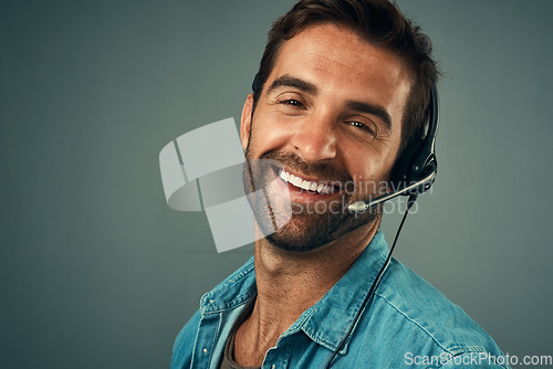 Image of Happy man, portrait and headphones for call center consulting against a grey studio background. Face of friendly male consultant agent with smile and headset in contact us for help or online advice