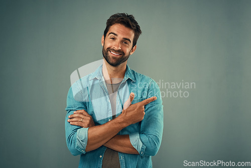 Image of Point, happy and portrait of man in studio on gray background for announcement, news and information. Fashion, mockup space and male person with pointing hand sign for promotion, choice and decision